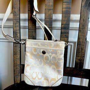 Coach cream crossbody.  8.5” tall & 7” wide with a front pocket.